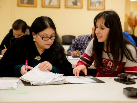 Instructor Gabriela Garibay (right) helps student Ana I. Perez with math on April 11, 2017 in Stockton, Calif., as part of a federal grant-funded program for migrant workers to obtain high school diplomas.